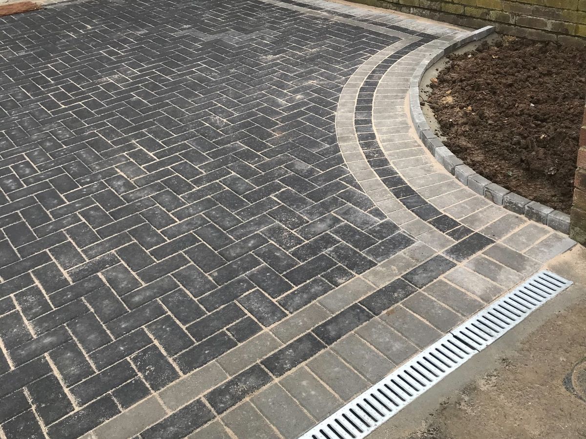 A completed block paved driveway with a curved soldier course