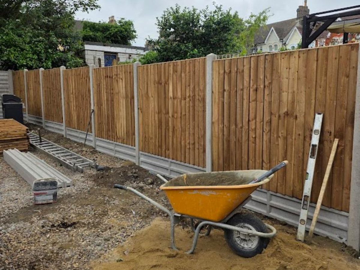 A finished closeboard fence beside newly laid paving