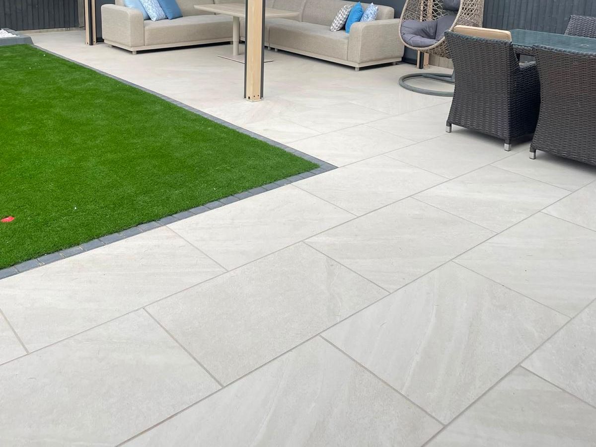 A porcelain paved patio beside a garden room