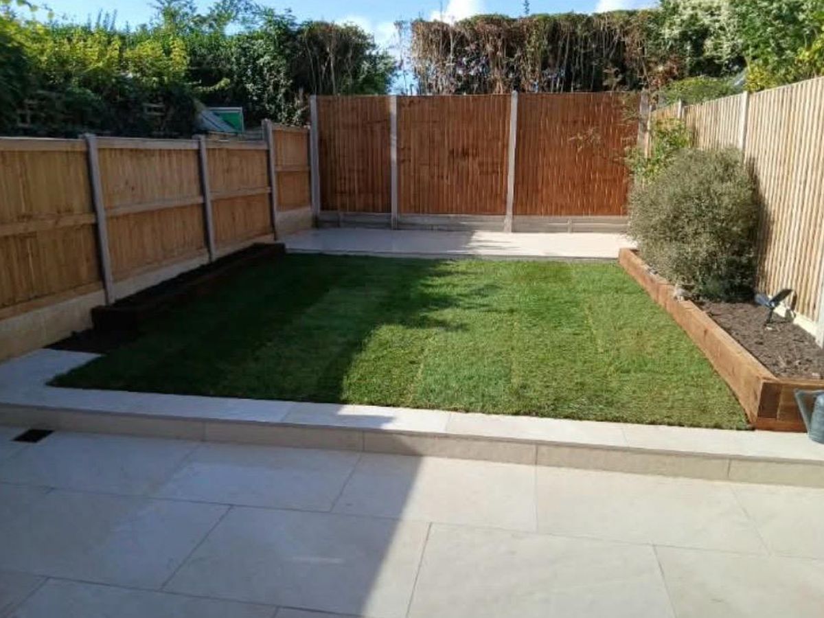 The same Hoo garden after a full makeover, with new paving, a fresh lawn edged in timber sleepers and replacement fencing across the rear boundary