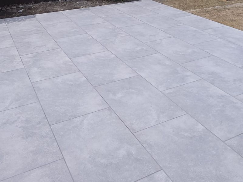Large-format grey porcelain patio paving laid with tight joints